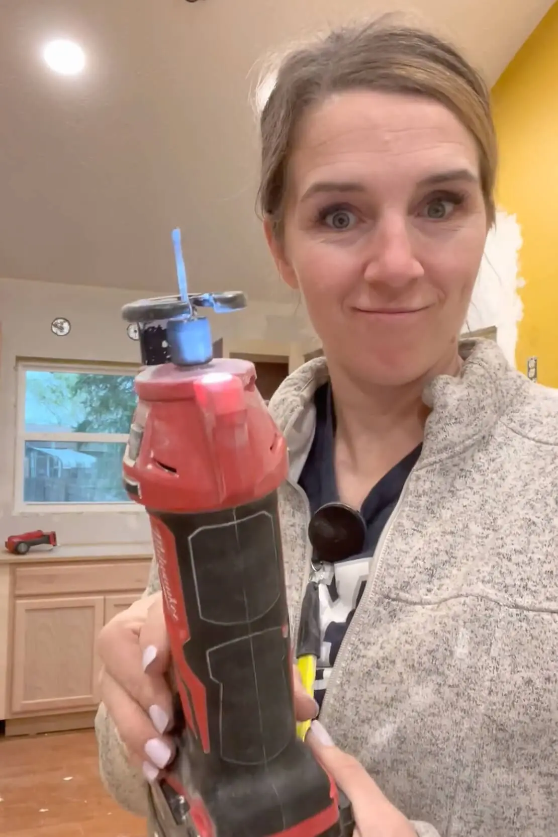 Demonstrating a drywall cut out tool.